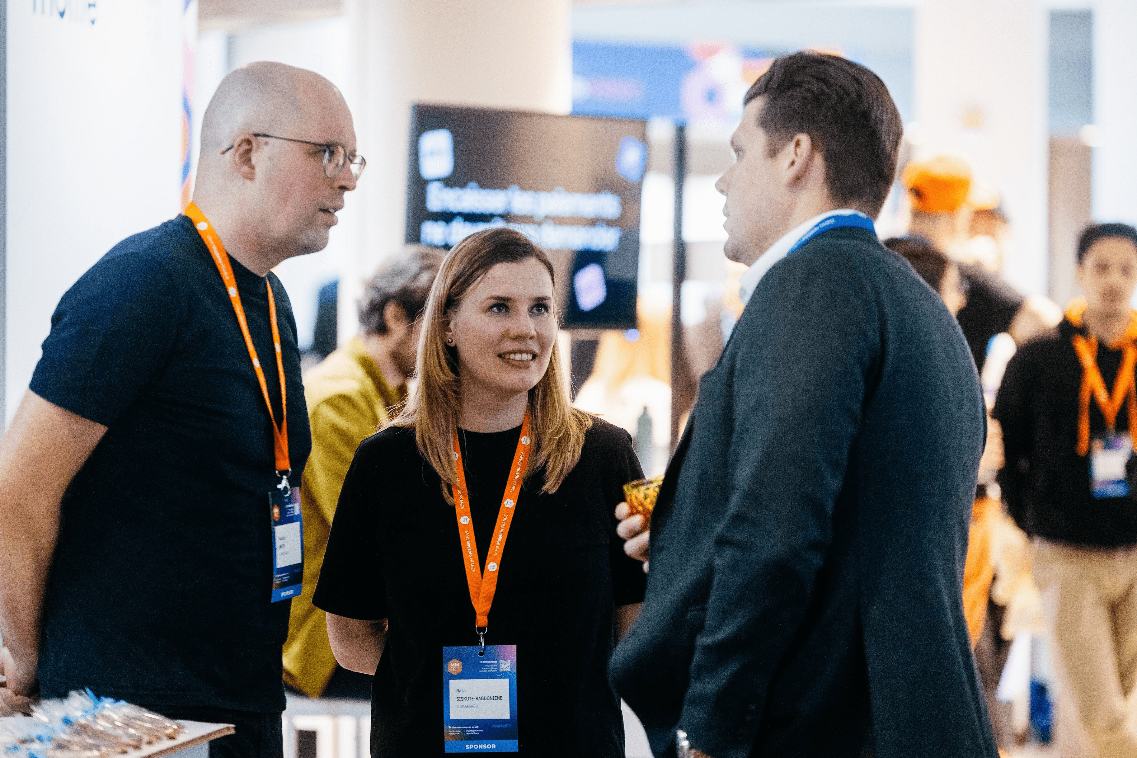 LupaSearch team members networking with visitors at an industry event