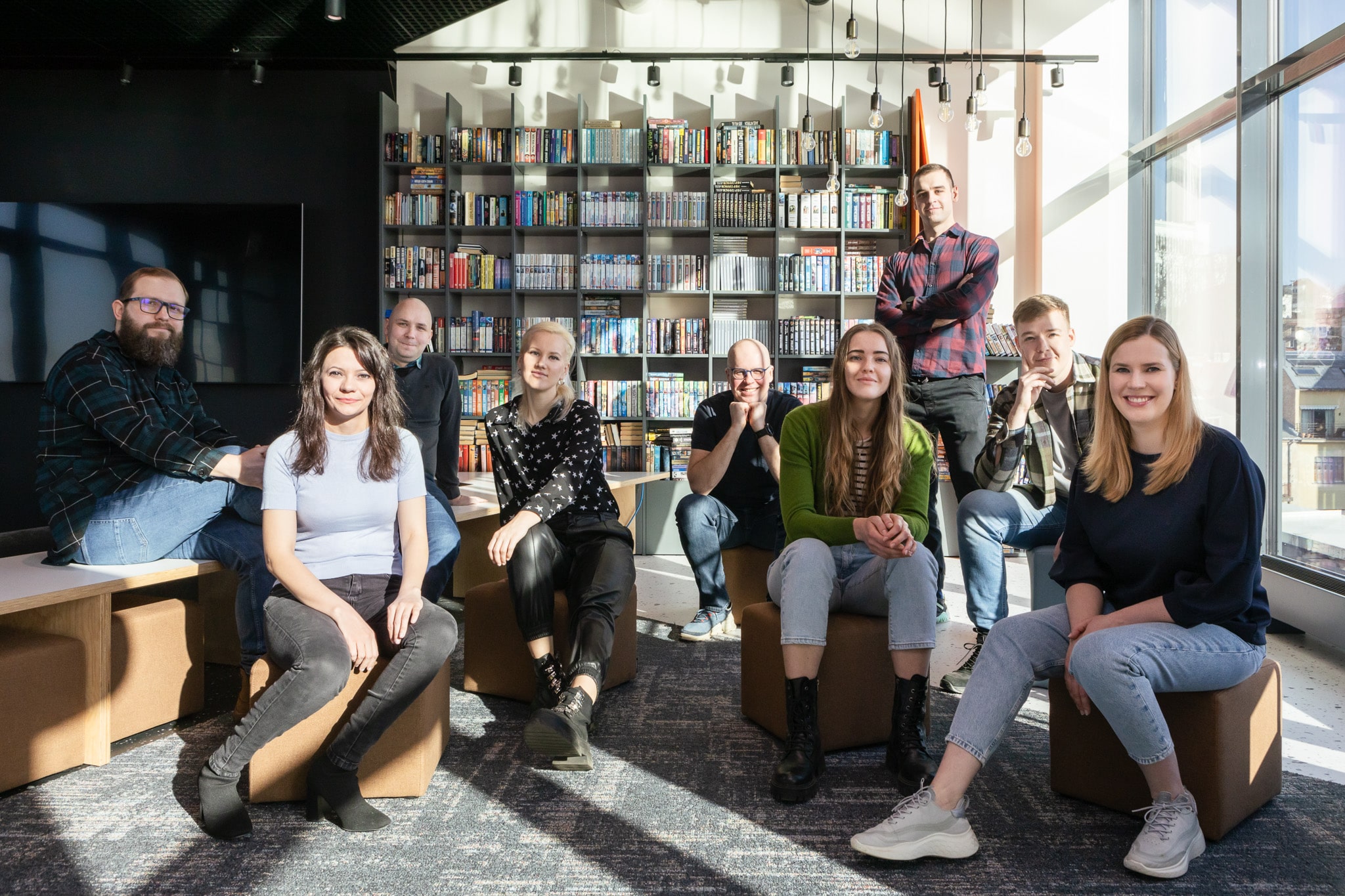 LupaSearch product and engineering team sitting together in a modern office library